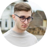 young male with combed hair with dark circular glasses frames