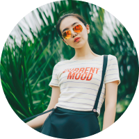 young stylish Asian woman with large round orange-red sunglasses lens